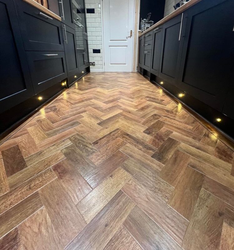 Karndean Art Select Parquet Collection in Auburn Oak - Herringbone laying pattern with black stripping border