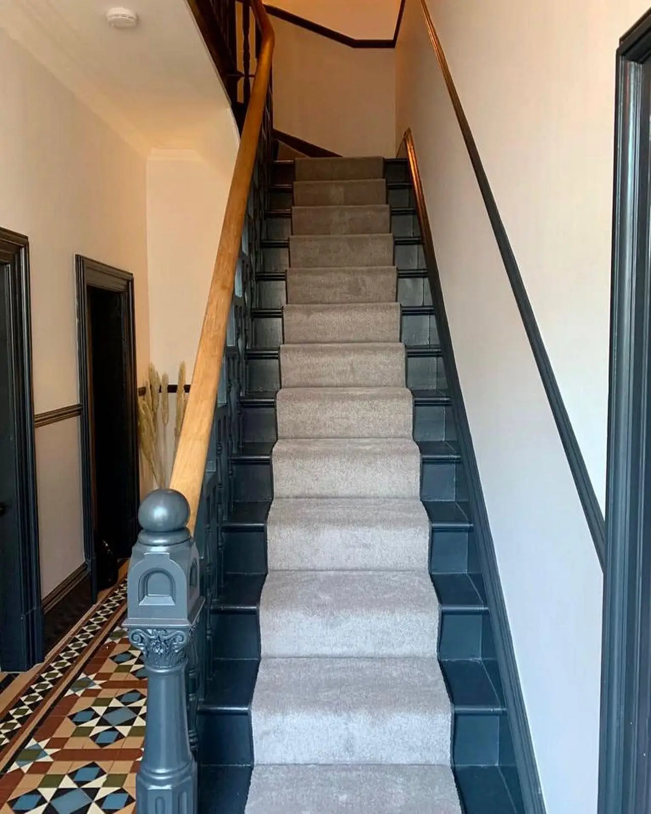 Beige Stair Runner with Contrasting Black Edge Tape Runner on a Dark Wood Staircase with Ornate Hall Floor Made and Fitted by Floormaster Yorkshire
